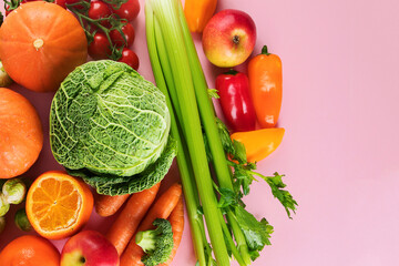 Assortment of vegetables and fruits on colorful background.