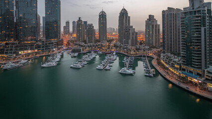 Fototapeta na wymiar Luxury yacht bay in the city aerial night to day timelapse in Dubai marina