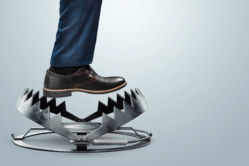 Close-up of a businessman's foot over a bear trap. The concept of problem solving, failure, crisis,...