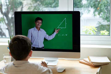 Smart little boy attending trigonometry online class