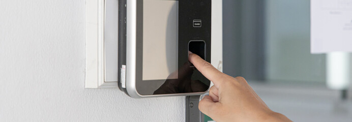 Finger print scan, Male employees press sensors to record company attendance time and after work,...