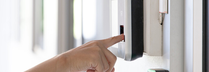 Finger print scan, Male employees press sensors to record company attendance time and after work,...