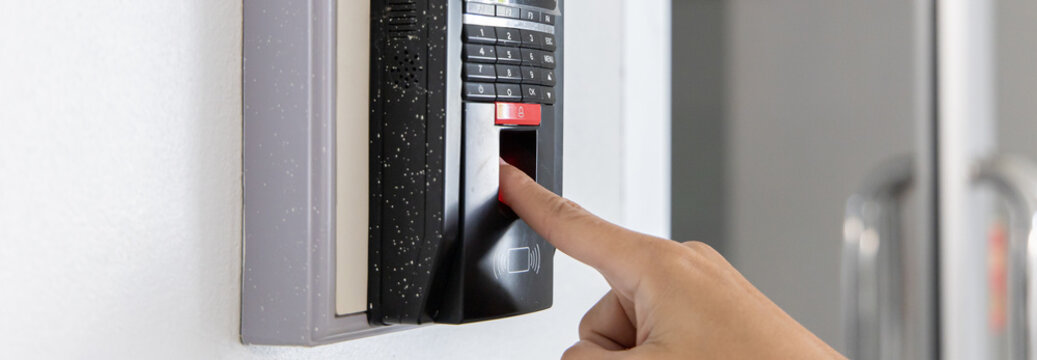 Finger print scan, Male employees press sensors to record company attendance time and after work, Time Recorder Attendance - Out work, Encryption for identity verification or electronic signing