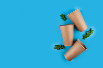 Disposable paper biodegradable cups and green leaves