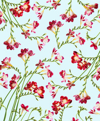 Floral pattern with red flowers and curved green stems at blue backdrop. Top view.