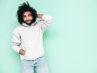 Handsome smiling hipster  model.Sexy unshaven Arabian man dressed in summer stylish hoodie clothes....