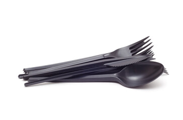 a bunch of black plastic spoons, forks and knives isplated on white background