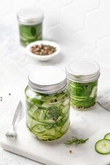 Conservation. Pickled cucumbers. Slices of Marinated cucumbers in glass jars. Homemade fermented cucumbers