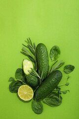 Flat lay with vegetables and fruits on green background