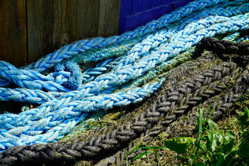 strings and boat rope in boat harbor on floor outdoor