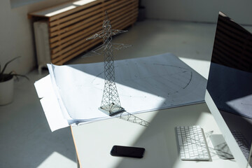 Electricity pylon model and blueprint on desk