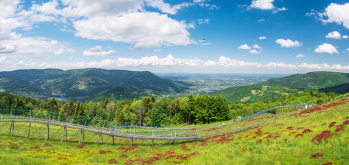 Panoramic view from the top of the heat towards the north. The summer toboggan run . Lake Czanieckie and the Międzybrodzkie in the background. View of the Silesian Beskids and the Little Beskids.