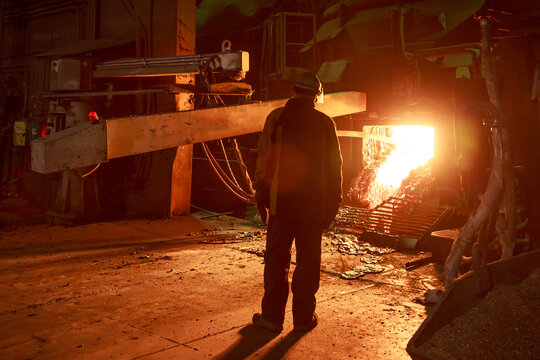 Steel foundry worker at blast furnace workshop.