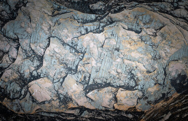Abstract surface wallpaper of stone textured with the dark and vignetted effect for background and text design.