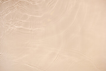 Transparent beige clear water surface texture with ripples, splashes. Abstract nature background...