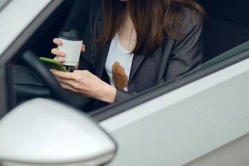 Woman spilled hot coffee on herself while texting while driving.  daily life dirty stain