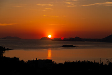 Sunset over mountains and sea. Adriatic coast of Croatia.