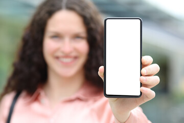 Happy elegant woman showing blank phone screen