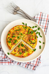 Frittata Slices in a Plate with Forks Top Down Vertical Photo on White Background