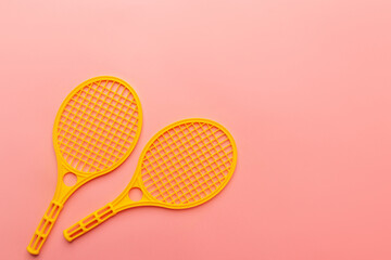 Two tennis rockets on the pink background. Empty space. Sport kids concept