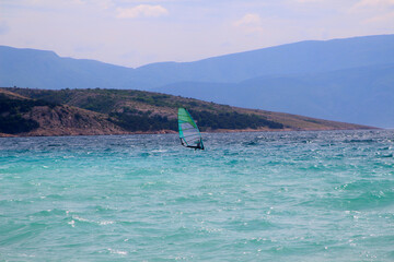 Windsurfing at the coast among islands (Baska, Krk island, Croatia)