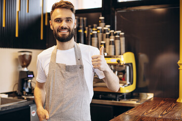 Young male barista working at a coffee house