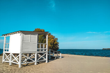 White wooden house for lifeguards on the water at the beach.