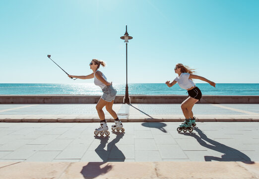 Young blonde women practicing sport outdoors on the seafront in summer