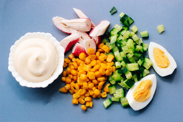 Sliced crab sticks, diced cucumber and egg with mayonnaise for salad.