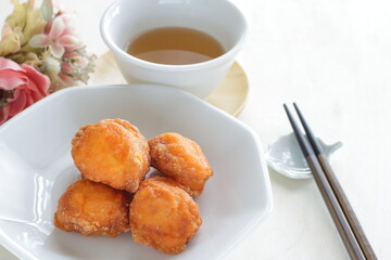 Chinese sweet dim sum food, deep fried ball on white dish