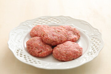 Homemade hamburger patty on white plate for prepared cooking ingredient 