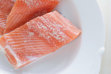 Prepared Salmon fish fillet on white plate for cooking ingredient image