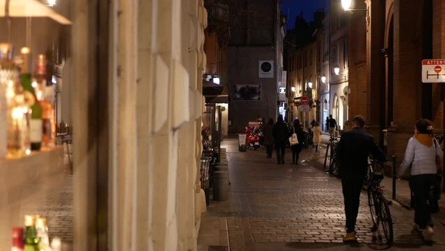 Old district at night, blurry bottles in a bar on the foreground, french city
