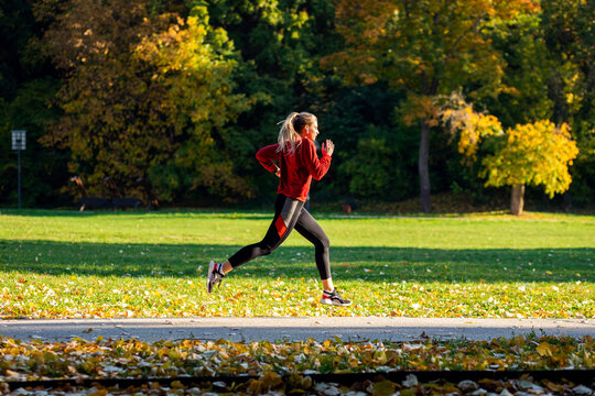 Young woman running in park.