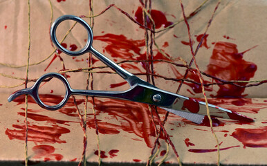 scissors with thread and blood