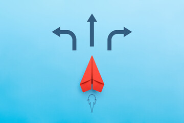Red paper plane on road with many direction arrow choices or move forward, concept solution and...