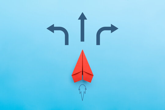 Red paper plane on road with many direction arrow choices or move forward, concept solution and start
