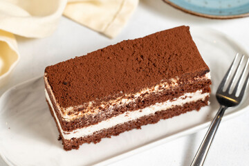 Tiramisu cake. Layered tiramisu cake on a white background. close up