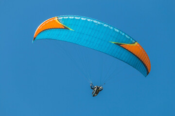 Twin paraglider. Paragliding against the blue sky.