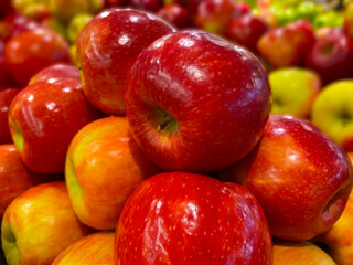Retail store produce pile of beautiful colorful red apples