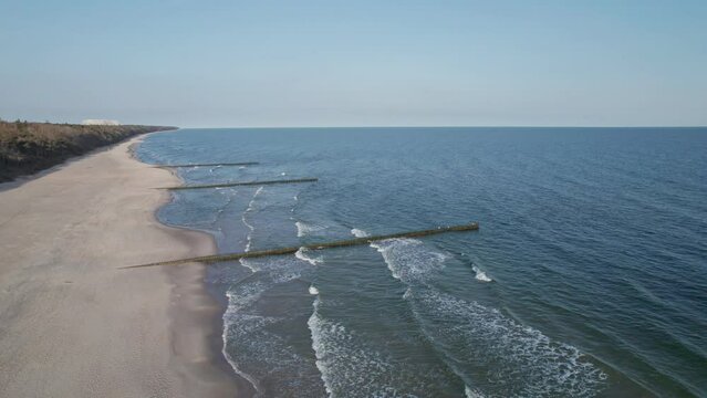 Breakwaters on the beach at sunrise, top view