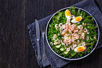 pink cocktail shrimps salad with veggies on plate