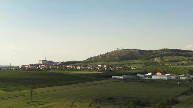 Mikulow town below Svatý Kopeček hill in Moravia landscape, drone shot.
