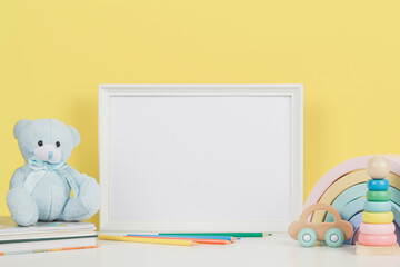 Blank horizontal wooden frame mockup, baby room art, white wood blank frame with baby kid toys,...