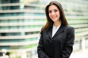 Confident young female manager outdoor in a modern urban setting