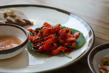 It is a Korean dish of thinly sliced boiled pork wrapped in spicy radish and pickled cabbage. It is sometimes eaten with salted shrimp and wrapped in kimchi.