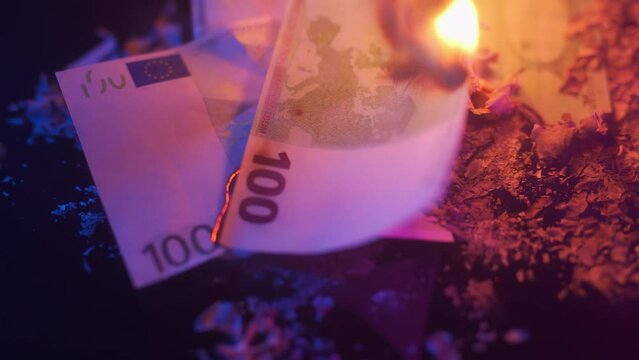 Burning euro banknotes. Concept of financial crisis and lockdown or inflation