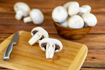 Fresh white champignons on a cutting board.