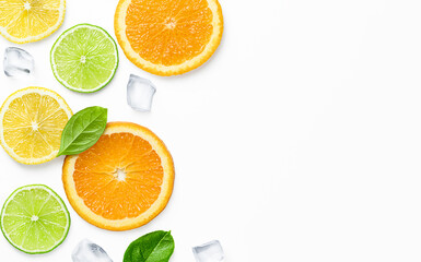 ice cubes, leaves and slices of orange, lemon, lime on a light background, top view