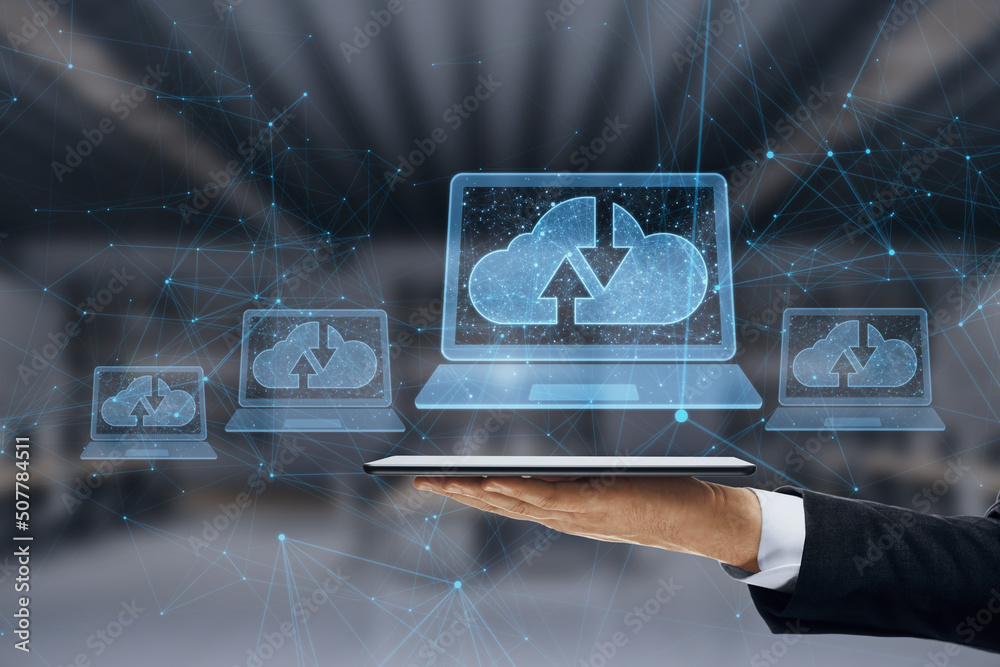 Poster Close up of businessman hand holding tablet with abstract polygonal digital laptop with cloud computing hologram on blurry interior background. Database and information concept. Double exposure.